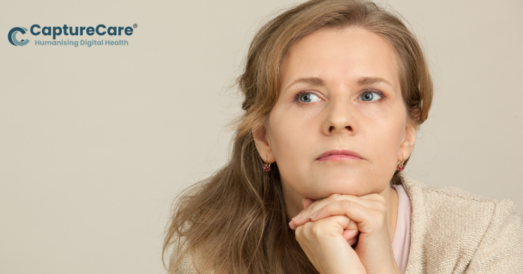 Person with hands on chin, thoughtful.